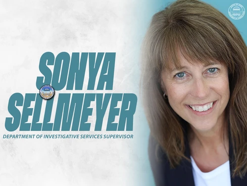 Sellmeyer in front of a gray background with her name in writing next to her