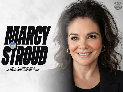 Stroud in front of a gray background next to the words "Marcy Stroud"