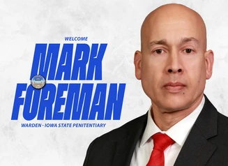 A headshot of Mark Foreman next to the DOC Seal and the words Welcome Mark  Foreman, Warden, Iowa State Penitentiary
