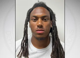 McGee in front of a gray background