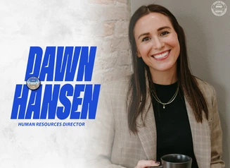 Dawn Hansen in front of a gray background