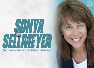 Sellmeyer in front of a gray background with her name in writing next to her