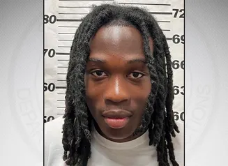 Moore in front of a gray background